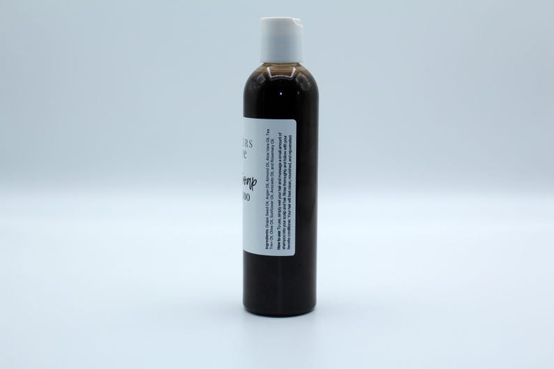 May include: A brown glass bottle with a white pump top and a white label that reads "Citrus & Hemp Shampoo".