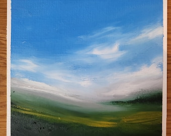 May include: A painting of a landscape with a blue sky, white clouds, and green and yellow fields. The painting is signed in the bottom left corner.