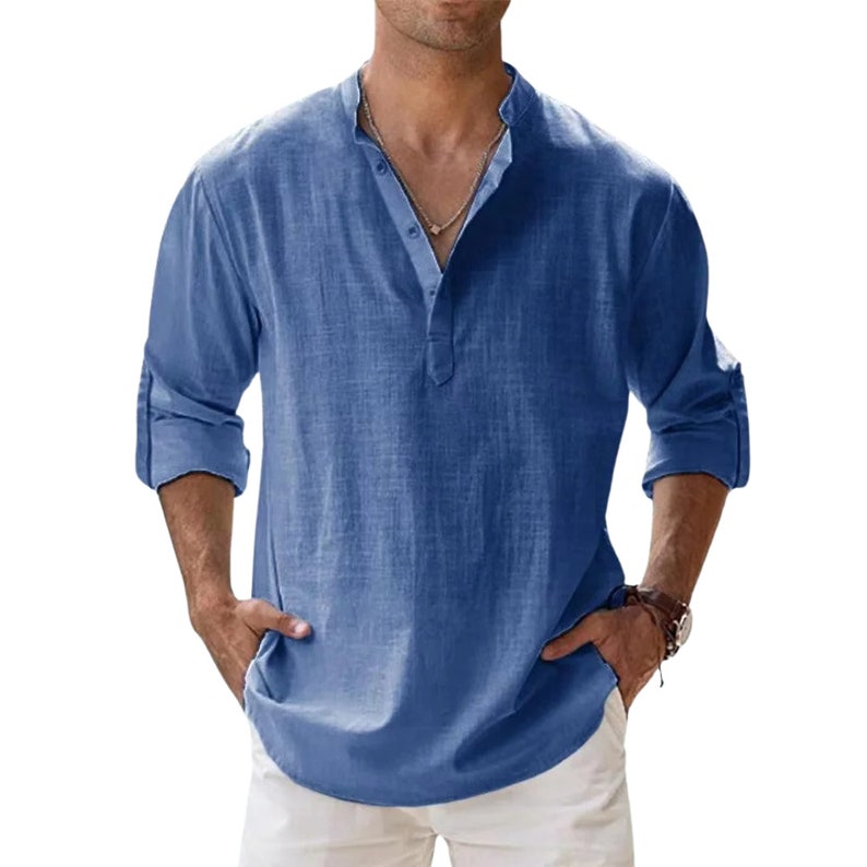 a man wearing a blue shirt and white pants