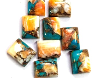May include: A collection of rectangular gemstone cabochons. The stones feature a mix of colors, including turquoise, orange, white, and gold. Each stone has a unique pattern and is set against a white background. These stones are suitable for jewelry making.