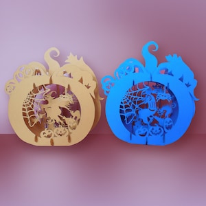 May include: Two Halloween-themed pumpkin-shaped paper lanterns. One is gold and the other is blue. Both feature a witch flying on a broomstick, a spider web, and pumpkins.