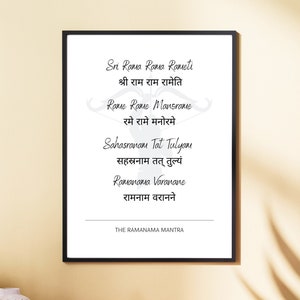 May include: A black framed print with a white background and black text. The text is a mantra in Sanskrit and English. The mantra is "Sri Rama Rama Rameti,  श्री राम राम रामेति, Rame Rame Mansrame, रमे रामे मनोरमे, Sahasranam Tat Tulyam, सहस्रनाम तत् तुल्यं, Ramanama Varanane, रामनाम वरानने". The text at the bottom of the print reads "THE RAMANAMA MANTRA".