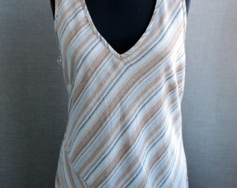 May include: A sleeveless dress with a V-neckline and a diagonal striped pattern in shades of brown, white, and blue.