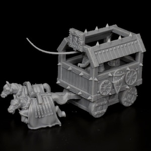 May include: A grey plastic model of a medieval siege wagon with two horses pulling it. The wagon has a wooden frame with a roof and a spiked railing. There are two figures inside the wagon.