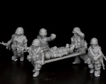 May include: A group of five gray plastic toy soldiers, one of whom is carrying a wounded soldier on a stretcher. The soldiers are wearing helmets and carrying weapons.