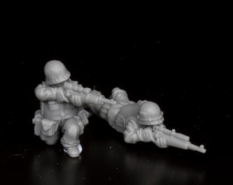 May include: Two gray plastic toy soldiers in a combat pose. One soldier is kneeling and aiming a rifle, while the other is lying down and aiming a rifle.