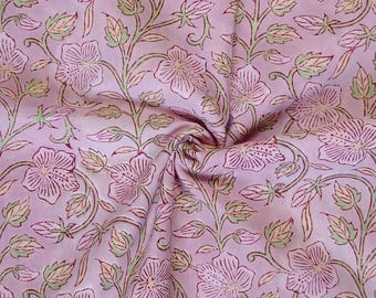 May include: Pink fabric with a floral print. The flowers are pink and green and have a vintage style.