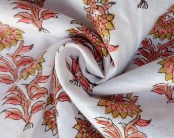 May include: White cotton fabric with a repeating pattern of pink and brown floral designs.