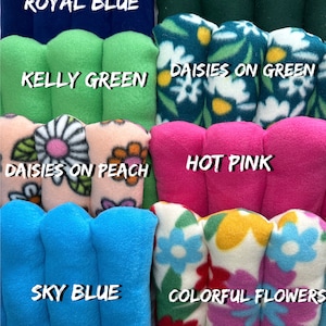 May include: A collection of fleece fabric squares in various colors and patterns, including royal blue, hunter green, kelly green, daisies on green, daisies on peach, hot pink, sky blue, and colorful flowers. The fabric squares are labeled with their respective colors and patterns. The text "ETSY MY3GUINEAPIGSSHOP" is visible at the bottom of the image.