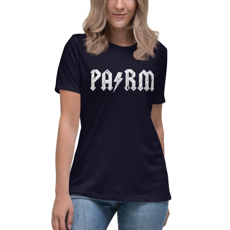 May include: A navy blue t-shirt with a white distressed graphic of the word "PARM" in a rock and roll font with a lightning bolt.