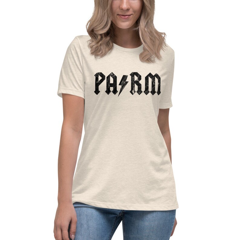 May include: A light beige t-shirt with a black graphic print of the word "PARM" in a rock and roll style font with a lightning bolt between the "A" and "R".