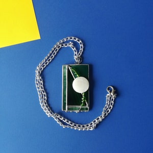 Rectangular pendant made of stained glass and glass beads. A necklace with an interesting artistic pendant. Green designed pendant