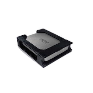 May include: A black 3D-printed enclosure holding a silver Crucial solid-state drive. The enclosure has a rectangular shape with a cutout for the drive's connectors. The Crucial drive is visible inside the enclosure.