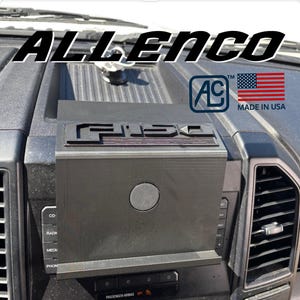 May include: Black dashboard organizer with the word "F-150" in raised letters. The organizer is mounted on a vehicle dashboard. The image also includes the text "ALLENCO", a logo, and a "Made in USA" label.