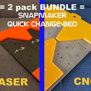 May include: Two-pack bundle of Snapmaker quick change beds. One bed is orange and was cut with a laser. The other bed is yellow and was cut with a CNC machine. Both beds have a black base.