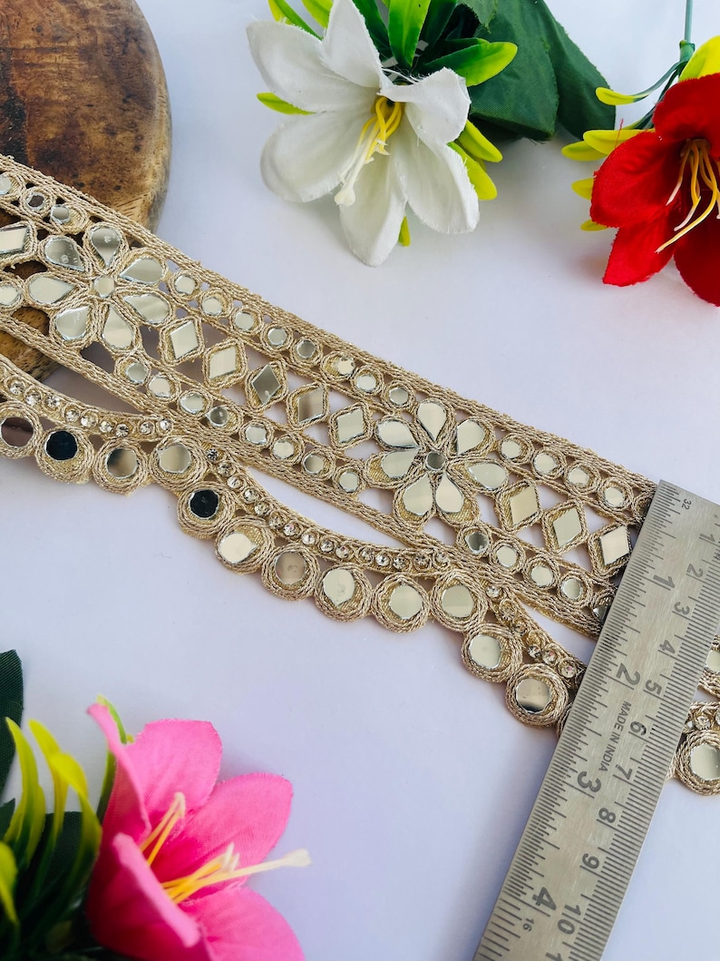 2.75 inch wide scallop mirror trim in gold color featuring intricate Indian embroidery and reflective mirror work, ideal for waist wear jewelry, kamarband designs, lehenga borders, saree edging, blouse decoration, bridal costumes, festive ethnic outfits, dance wear, DIY fashion projects, and traditional Indian garment embellishment with luxury handcrafted finish