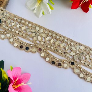 2.75 inch wide scallop mirror trim in gold color featuring intricate Indian embroidery and reflective mirror work, ideal for waist wear jewelry, kamarband designs, lehenga borders, saree edging, blouse decoration, bridal costumes, festive ethnic outfits, dance wear, DIY fashion projects, and traditional Indian garment embellishment with luxury handcrafted finish