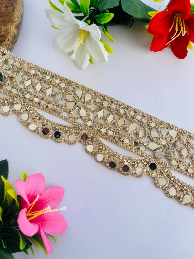 2.75 inch wide scallop mirror trim in gold color featuring intricate Indian embroidery and reflective mirror work, ideal for waist wear jewelry, kamarband designs, lehenga borders, saree edging, blouse decoration, bridal costumes, festive ethnic outfits, dance wear, DIY fashion projects, and traditional Indian garment embellishment with luxury handcrafted finish