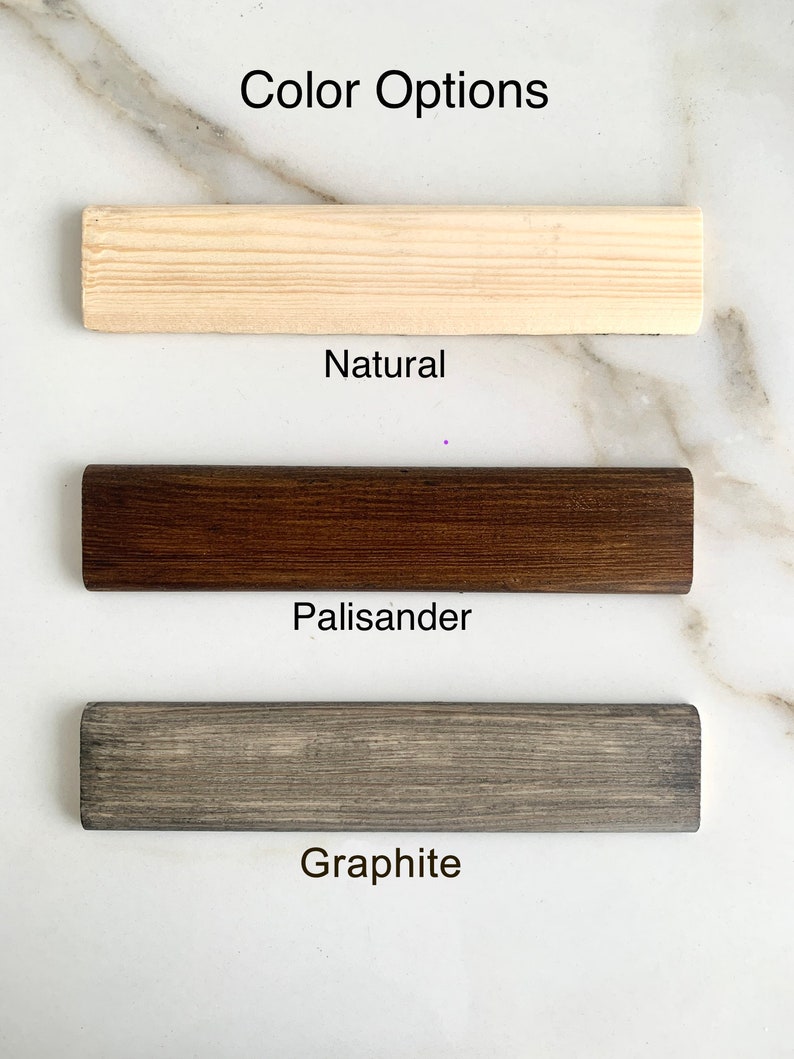 May include: Three wood samples showing different color options: Natural, Palisander, and Graphite.
