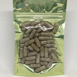 May include: A green resealable pouch filled with a large quantity of brown capsules.