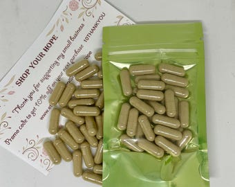 May include: A green resealable pouch filled with approximately 40 tan capsules. The pouch is lying on a white surface next to a white card with the text "SHOP YOUR HOPE" and "Thank you for supporting my small business. Promo code to get 10% off on your next purchase 10THANKYOU www.et/S 'ope".