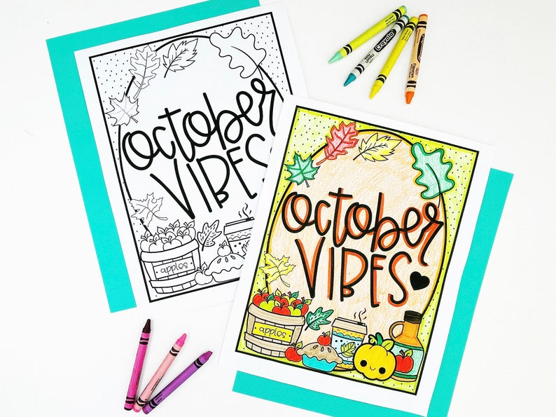 May include: Two "October VIBES" coloring pages with fall-themed illustrations, including apples, leaves, and a pumpkin. Crayons in various colors are scattered around the pages. One page is colored, the other is a black and white outline.
