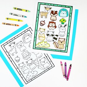 May include: Two coloring pages with woodland animal illustrations, including a deer, fox, and raccoon, are displayed with crayons. One page is colored with green, yellow, and brown. Crayons in various colors are scattered around the pages.