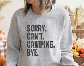 May include: Gray sweatshirt with the text "SORRY. CAN'T. CAMPING. BYE." printed in black.