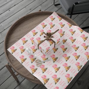May include: Pink and white wrapping paper with a repeating pattern of Winnie the Pooh and Piglet holding pink balloons. The text on the paper reads "Happy 1st Birthday" and "Love The [Family Name] Family".