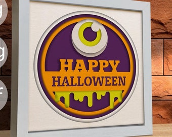 May include: A white frame with a purple and orange circle inside. The circle has a yellow eye with a white pupil and the text "HAPPY HALLOWEEN" in orange letters.