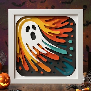 Puede incluir: Una obra de arte en papel con temática de Halloween enmarcada. La obra presenta un fantasma blanco con ojos y boca negros, sobre un fondo en capas de tonos naranja, amarillo y turquesa. El marco es blanco y el diseño general es cuadrado.