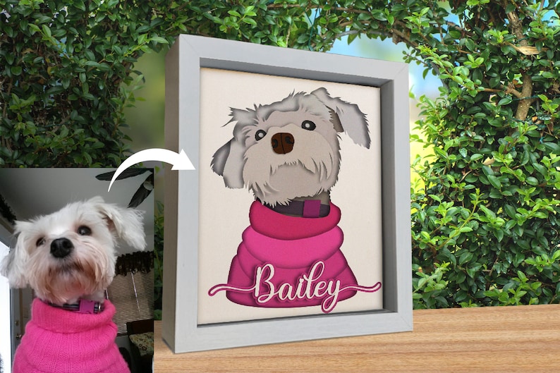 May include: A white dog with a pink sweater and the name "Bailey" written in pink cursive on a white canvas in a gray frame.