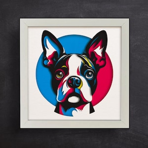 May include: A colorful paper cut-out illustration of a Boston Terrier dog's face. The dog's face is surrounded by a red and blue circle.