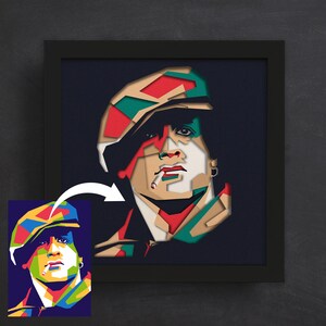 May include: A colorful, geometric portrait of a person wearing a hat and smoking a cigarette. The portrait is made in a paper cut style.