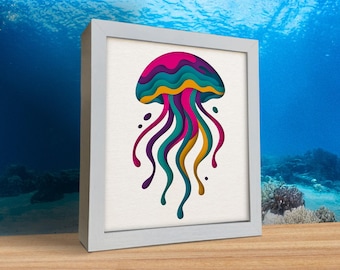 May include: A framed art print featuring a colorful jellyfish design. The jellyfish is depicted with layers of pink, teal, yellow, and purple, with long, flowing tentacles. The artwork is set against a white background and framed in a white border.