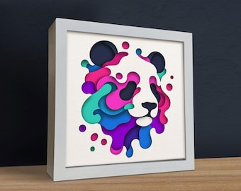 May include: A white framed picture with a colorful paper cut-out design of a panda bear. The panda is made of pink, blue, purple, green, and black paper.