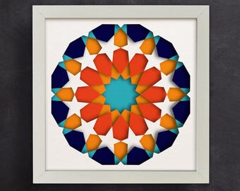 May include: A framed geometric design with a blue, orange, and turquoise color scheme. The design is made up of overlapping shapes that create a starburst pattern.
