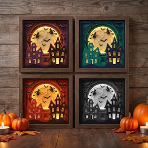 May include: Four square shadow box wall art pieces featuring layered paper cutouts of a haunted house, a large full moon, and flying witches on broomsticks. Each frame displays a different color scheme: purple, green, orange, and grayscale.