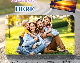 May include: A rectangular metal license plate featuring a custom full-color photograph of a family sitting on grass. The plate has two mounting slots at the top and bottom. The image displays a smiling family of four outdoors in a park setting.