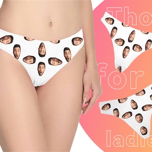 May include: White underwear with a repeating pattern of a man's face. The underwear is shown on a model. The text "Thongs for ladies" is visible in the background.