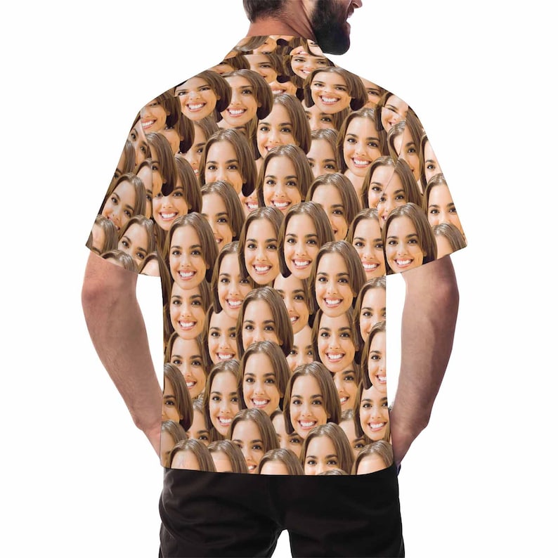 May include: A short-sleeved button-up shirt with a pattern of many faces. The shirt is white with a light brown background.