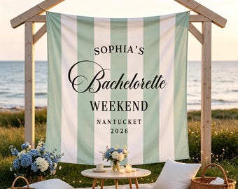 May include: A rectangular fabric banner featuring vertical sage green and white stripes. The text reads SOPHIA'S Bachelorette WEEKEND NANTUCKET 2026 in black lettering. The banner is suspended from a wooden frame structure outdoors.