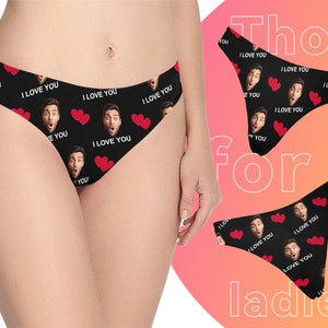 May include: Black underwear with a repeating pattern of red hearts and a man's face with the text "I love you".