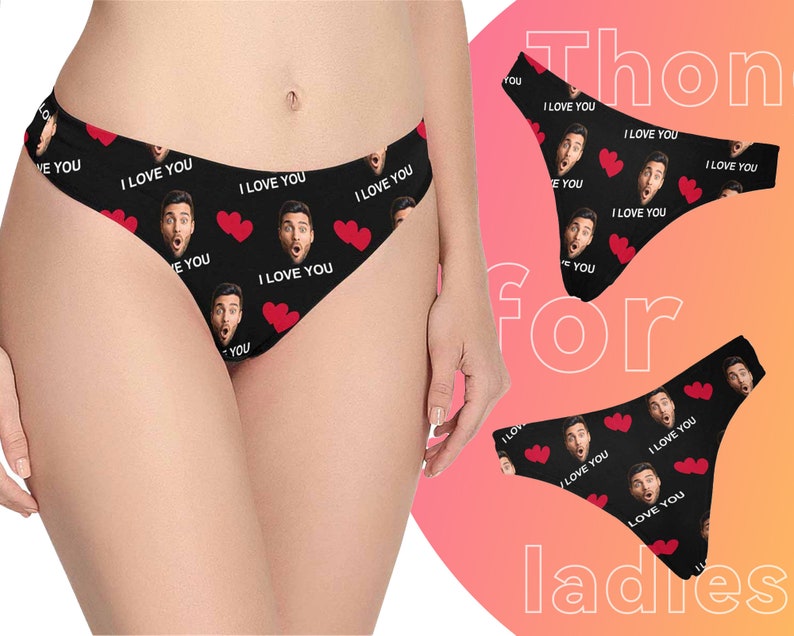 May include: Black underwear with a repeating pattern of red hearts and a man's face with the text "I love you".