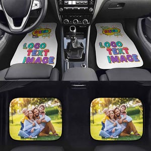 May include: Two white car floor mats featuring a colorful graphic with the text "YOUR DESIGN HERE" and "LOGO TEXT IMAGE" in a comic style, positioned below a car dashboard. Two rear car mats display a full-color photograph of a family of four.