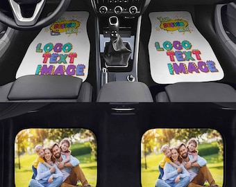 May include: Two white car floor mats featuring a colorful graphic with the text "YOUR DESIGN HERE" and "LOGO TEXT IMAGE" in a comic style, positioned below a car dashboard. Two rear car mats display a full-color photograph of a family of four.
