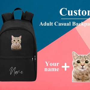 May include: Black canvas backpack with a cat image and the word "Name" in white text.  Custom Adult Casual Backpack.