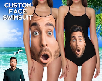 May include: Two people wearing black swimsuits with a face printed on the front. The text "CUSTOM FACE SWIMSUIT" is at the top of the image.