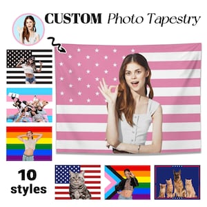 May include: A custom photo tapestry with a pink and white American flag design. The image includes a woman making an 'okay' gesture, and several other flag designs. The text reads "CUSTOM Photo Tapestry" and "10 styles".