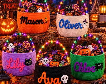 May include: Five round woven baskets in orange, white, purple, black, and green, each featuring a personalized name in script, a colorful LED-lit handle, and filled with assorted Halloween candies, small pumpkins, ghosts, and skull decorations.